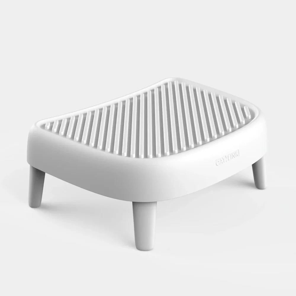 White plastic textured cat litter trap step and ramp with four legs.