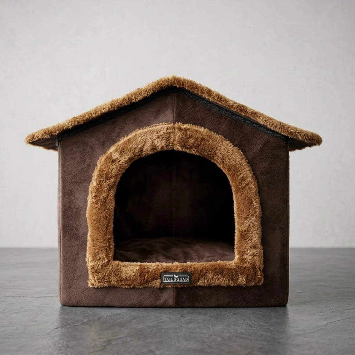 Front view of the brown plush Tail Squad indoor cat cave and small dog house bed with fuzzy fleece trimming.